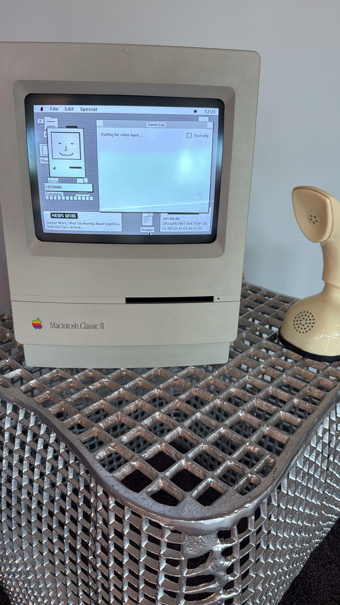 Happy Mac on the Macintosh Classic II CRT, listening, with the Ericofon handset beside it